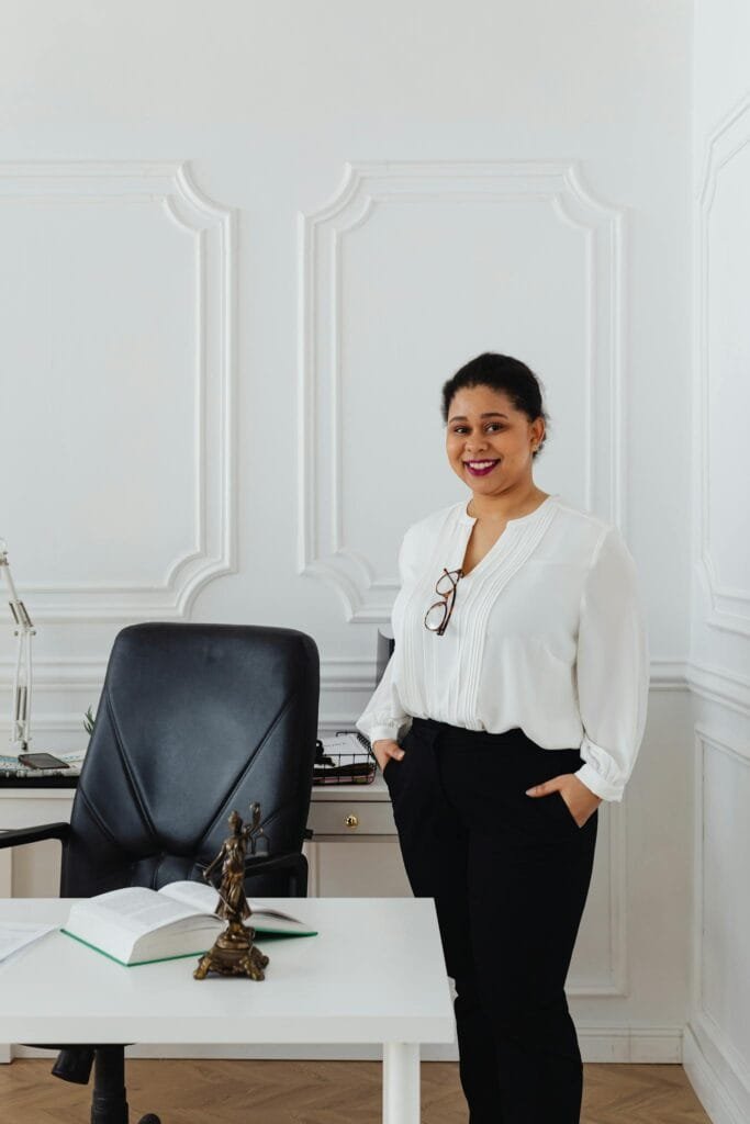 Confident businesswoman smiling in elegant office setting, perfect for corporate themes.